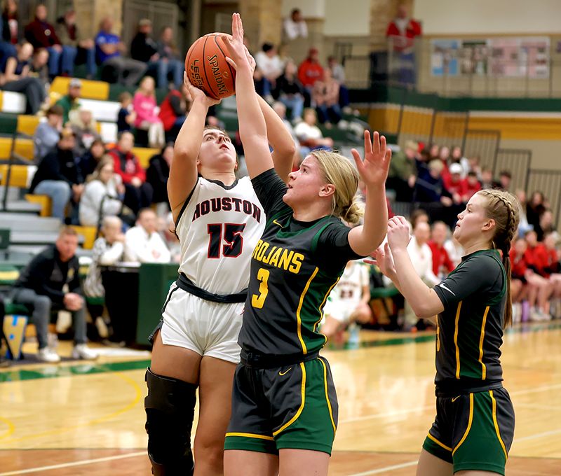 Rushford-Petersons’ Emily Helgemoe challenges the shot of Houston’s Avery Kingsley in the teams’ non-conference game. R-P topped FC 54-35, the Hurricanes 58-49, and La Crescent/Hokah 76-47 on the week to improve to 17-8 on the year. Photo by Craig Johnson