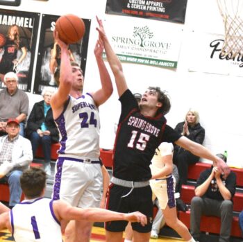 Grand Meadow’s Logan Grafe shoots while defended by Spring Grove’s Emery Bartell. Grafe had game highs with a 15-point, 19-rebound double-double in the Superlark road win. GM finished with four wins to improve to 17-9 overall (they had 18 wins the past four years combined). Photo by Lee Epps