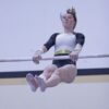 Caledonia/Spring Grove/Houston’s Harper Myhre competes on the uneven bars at gymnastics dual with PI/Z-M. Myhre won the all-around competition at the meet, though the Warriors lost as a team. Photo by Paul Trende