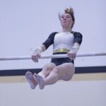 Caledonia/Spring Grove/Houston’s Harper Myhre competes on the uneven bars at gymnastics dual with PI/Z-M. Myhre won the all-around competition at the meet, though the Warriors lost as a team. Photo by Paul Trende
