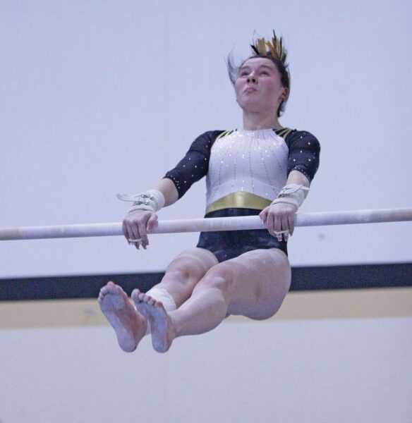 Caledonia/Spring Grove/Houston’s Harper Myhre competes on the uneven bars at gymnastics dual with PI/Z-M. Myhre won the all-around competition at the meet, though the Warriors lost as a team. Photo by Paul Trende