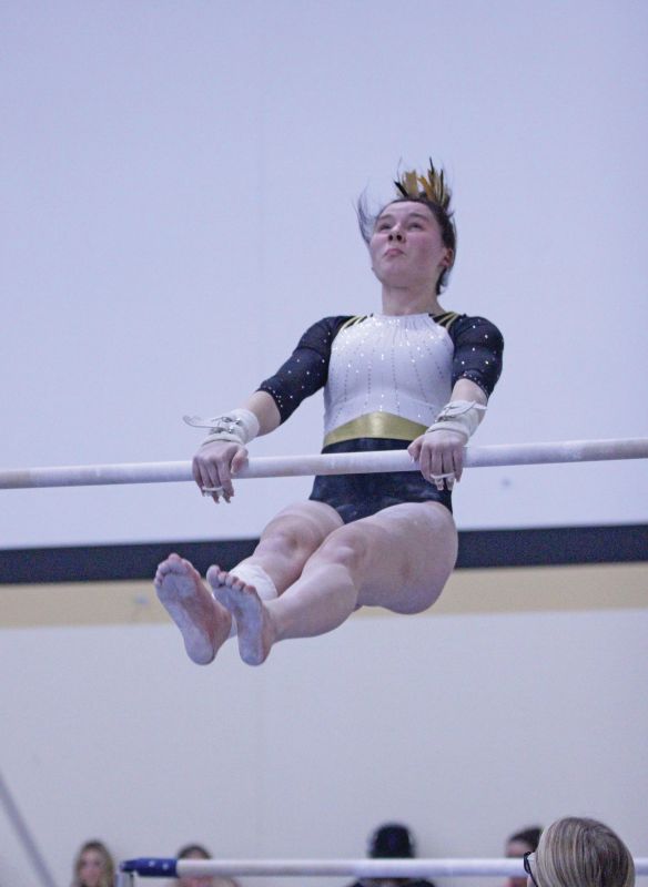 Caledonia/Spring Grove/Houston’s Harper Myhre competes on the uneven bars at gymnastics dual with PI/Z-M. Myhre won the all-around competition at the meet, though the Warriors lost as a team. Photo by Paul Trende