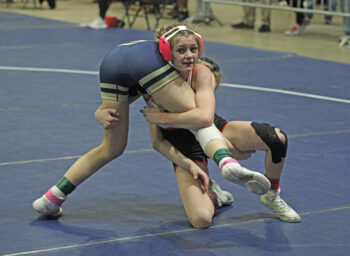 GMLOS’ Chloe Hubbard looks to finish the double-leg takedown of WEM/JWP’s Anaelyse Skidmore in a Section 2 106-pound true second match. Hubbard secured a 19-3 tech fall to win the match and earn a berth at state. Photo by Paul Trende