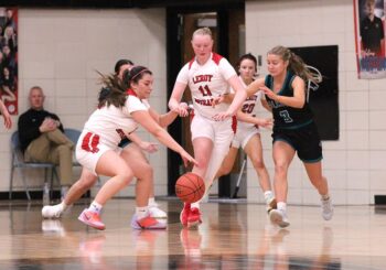 LeRoy-Ostrander’s Maria Almaraz-Nolt and Kendall Olson, Fillmore Central’s Aubrey Daniels, have eyes for a loose ball in the teams’ non-conference affair. FC won three games on the week to improve to 13-6 on the year. Photo by Paul Trende