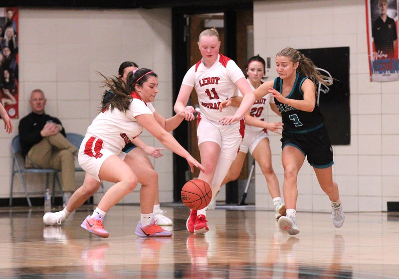 LeRoy-Ostrander’s Maria Almaraz-Nolt and Kendall Olson, Fillmore Central’s Aubrey Daniels, have eyes for a loose ball in the teams’ non-conference affair. FC won three games on the week to improve to 13-6 on the year. Photo by Paul Trende