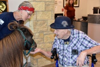 Gary warmly welcomed Baron the Brave and his handler, Cindy Forrer, to the veterans home in Preston, Minn., last August 12. Photo by Charlene Corson Selbee