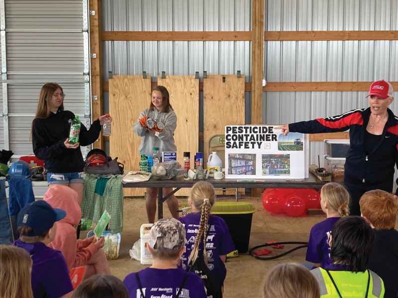Tessmer Farm Safety Day- All Caledonia FFA officers assist with the Tessmer Farm Safety Day at the Houston County Fairgrounds. Shown are Summer Colsch and Sophia Storlie assisting with the farm chemicals training workshop.