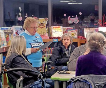 Ruth Franke addresses attendees during the Democratic precinct caucus Tuesday evening at Kingsland School as the group prepared to open with “America the Beautiful.” Photo by Zech Sindt