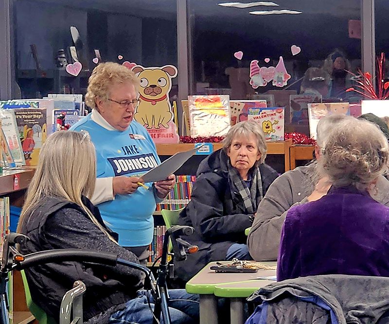 Ruth Franke addresses attendees during the Democratic precinct caucus Tuesday evening at Kingsland School as the group prepared to open with “America the Beautiful.” Photo by Zech Sindt
