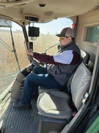 Plot harvest, senior Caden Voeltz operating the combine while harvesting the test plot. Supervised by Mitchel Berry.