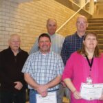 Six individuals were recognized for 25 years of service to the county. Front row Commissioner Randy Dahl, Jarad Carolan (county surveyor assistant), and Trista Ruen (highway shop accounting technician). Back row Commissioner Marc Prestby and Thomas Scheevel (engineering technician senior). Darrell Schmitt (engineering supervisor) is not pictured Photo by Karen Reisner
