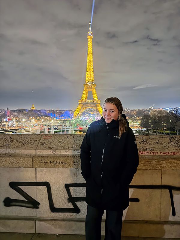 Kylie at the lighted Eiffel Tower.
