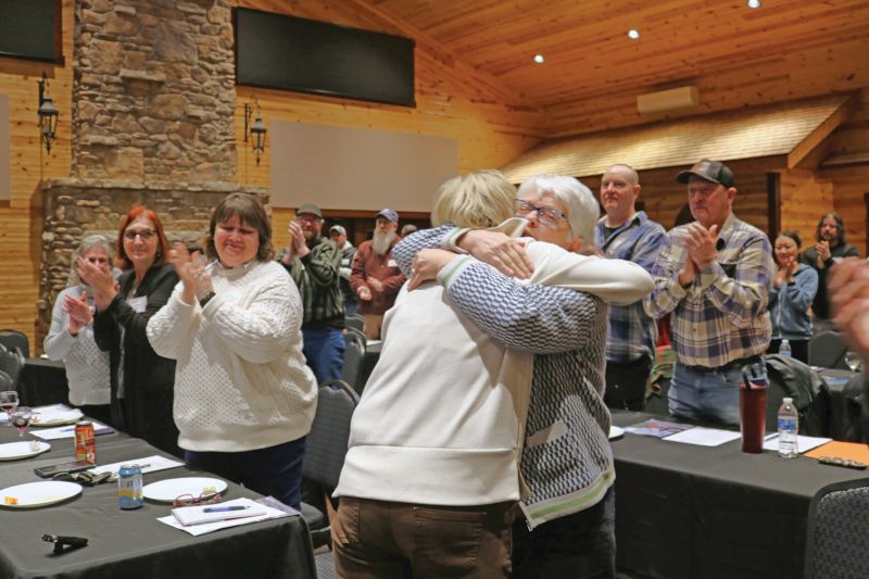 After giving the Keynote address at the LACC Annual Meeting, Lori Bakke gets a hug from Cheryl Lamon. Photo by Barb Jeffers