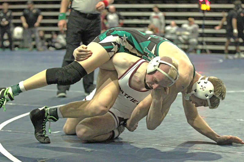 Chatfield’s Hunter Polikowsky does what he does and executes his best move, the fireman’s carry takedown on FCLMC’s Grant Daniels in a 145-pound finals match. Polikowsky won the match by fall but both athletes advanced to state. Photo by Paul Trende