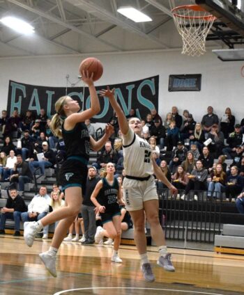 Fillmore Central’s Hannah Vaalemoen swoops in for a layup with Kingsland’s Lydia Redman defending. Vaalemoen scored 28 in the Falcons’ Round of 16 79-37 win. Photo by Deb Finseth
