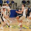 Caledonia’s Liam Kupietz and Coby Hammell (forefront), Zeke Gengler (background facing), and others celebrate the Warriors’ 58-55 overtime win over Zumbrota-Mazeppa in the 1AA semis. Caledonia is again back in the 1AA finals. Photo by Paul Trende