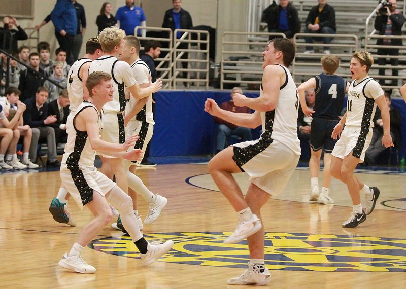 Caledonia’s Liam Kupietz and Coby Hammell (forefront), Zeke Gengler (background facing), and others celebrate the Warriors’ 58-55 overtime win over Zumbrota-Mazeppa in the 1AA semis. Caledonia is again back in the 1AA finals. Photo by Paul Trende