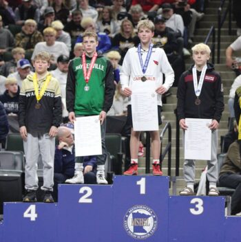 Gracing the state Class A podium at 107-pounds were Caledonia/Houston’s Kiptyn Meiners in fourth place (left) and Chatfield’s Joey Cady (right) in third place. In a section title rematch, Cady beat Meiners by 18-3 tech fall in both athletes last state match. Photo by Paul Trende