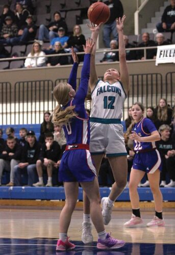 Fillmore Central’s Norah Nagel attacks the hoop late over Southland’s Avery Stroup in a 1A quarterfinal. FC built a 27-7 first half lead but fell 73-65. Photo by Paul Trende