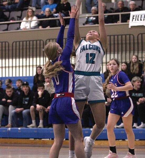 Fillmore Central’s Norah Nagel attacks the hoop late over Southland’s Avery Stroup in a 1A quarterfinal. FC built a 27-7 first half lead but fell 73-65. Photo by Paul Trende