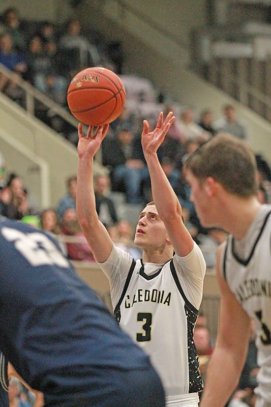 Caledonia sophomore Grant King focuses on one of four key late overtime free throws in the Warriors 1AA semifinal game with Zumbrota-Mazeppa. King hit all four to help the Warriors to a 58-55 victory in the extra session. Photo by Paul Trende