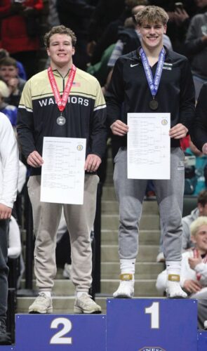 Caledonia/Houston sophomore Cooper Allen (left) takes the podium in the state runner-up position at 215-pounds, only losing to Holdingford’s Jaxon Bartkowicz (right) in the finals. Allen (32-12) won two early close decisions (5-4 and 4-3), then an 11-1 major to make the finals (where he fell by 7-1 decision). Photo by Paul Trende