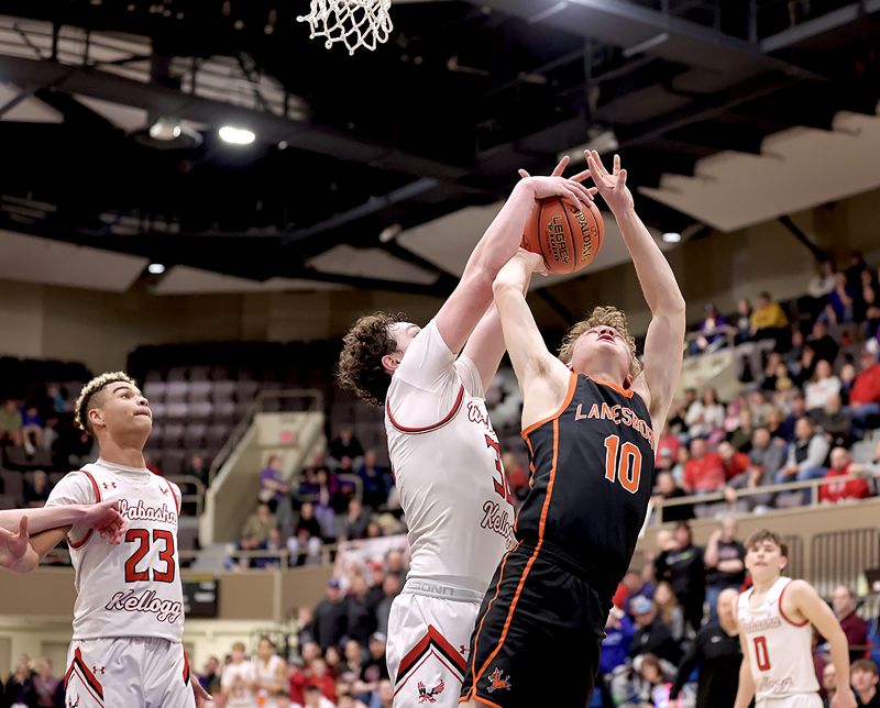 In a key play late in the game, Wabasha-Kellogg’s Bryar Ender blocks and rebounds the shot of Lanesboro’s Jack Brogle. Ender hit two free throws before the play, and two more after it, to lead 10-seed W-K to a 73-66 win over the 2-seed Burros, who finish a great season at 21-7. Photo by Craig Johnson