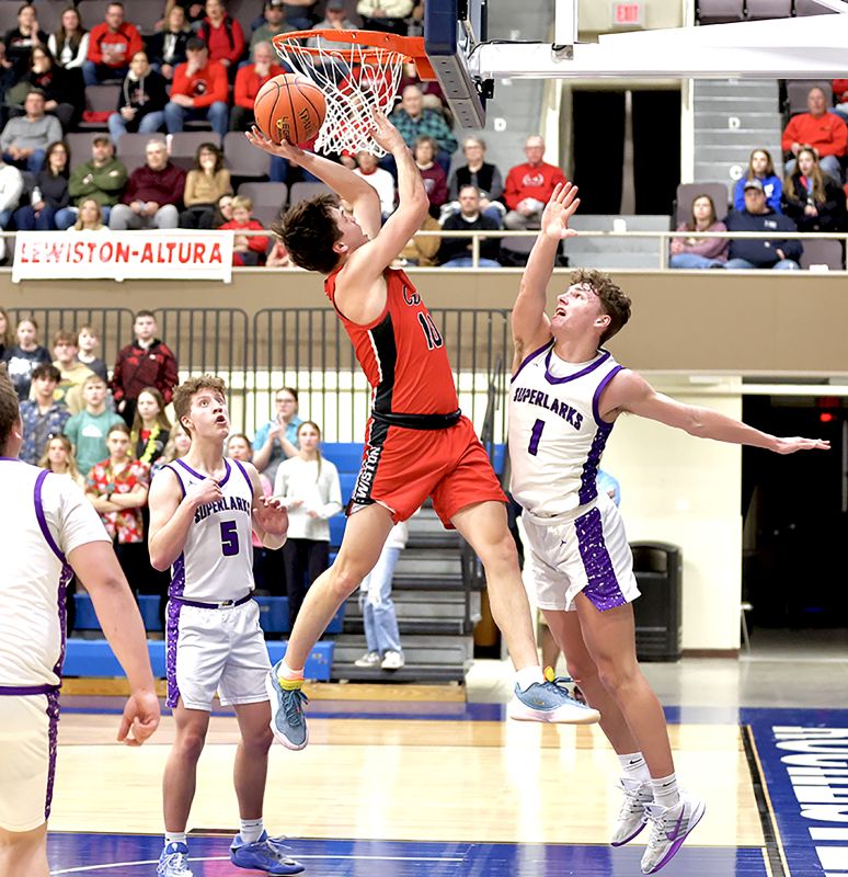 Grand Meadow’s Carter Glynn is late to deny Lewiston-Altura’s Seth Lubinski in the teams’ 1A quarterfinal contest. Lubinski scored a game-high 29 points, as the Cardinals goaded GM into 31 turnovers in an 85-53 Cardinal win. Photo by Craig Johnson
