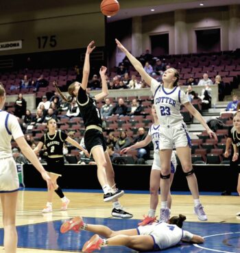 Cotter/Hope Lutheran’s Macy Donnenworth is on the floor and Caledonia’s Aubrie Klug has to shoot over the long arm of 6’2” Rambler Alayna Hardy in a 1AA quarterfinal. The Warriors (22-7) coasted to a 70-51 victory, but fell one game later to Red Wing 58-48 (as Klug was slowed by injury). Photo by Craig Johnson