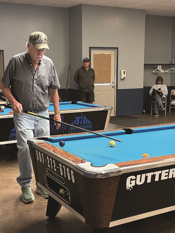 Chatfield native Doug Rowland sizes up his next shot on the table at the Fountain Community Center. Photo by Jason Sethre