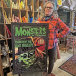Rushford artist Nicole Burk with her favorite mosaic, Famous Monsters of Filmland: Mystery of the Wax Museum. Photo by Charlene Corson Selbee
