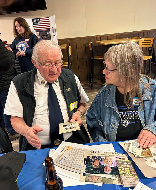 Jeff Zondlo and Wes’ sister Jean Slafter shared memories over pictures and mementos. Photo by Wanda Hanson