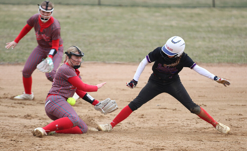 Houston’s Kylie Stinson tries to field a one hop throw to second base, as GMLOK’s Mollie Voigt gets the steal in the teams’ SEC battle. The #3 in Class A Hurricanes beat GMLOK 13-0 and went 4-0 on the week to improve to 7-0 on the year. Photo by Paul Trende