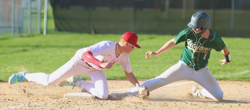 Rushford-Peterson’s Cayden Lea tries to get into third base safely ahead of the tag of Houston’s Tilden Witt. The Trojans won three games on the week, including topping the Hurricanes 14-0. Photo by Craig Johnson