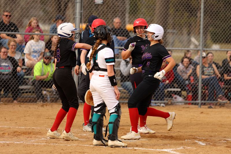 GMLOK’s Hailee Warren is met by teammates after hitting a home run in the Bulldogs’ 19-3 softball win over Fillmore Central/Lanesboro. Photo by Christine Vreeman