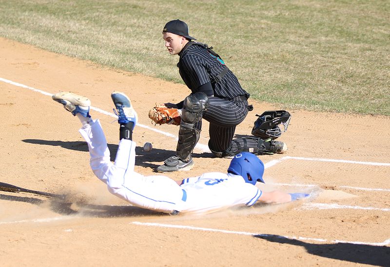 Mabel-Canton’s Nolan Garness slides in home safely with the game’s second run, as Fillmore Central/Lanesboro’s Levi Rogers fields the throw. M-C’s first two batters of the game walked and scored on an error to aid a 3-1 Cougar non-conference win. Photo by Paul Trende
