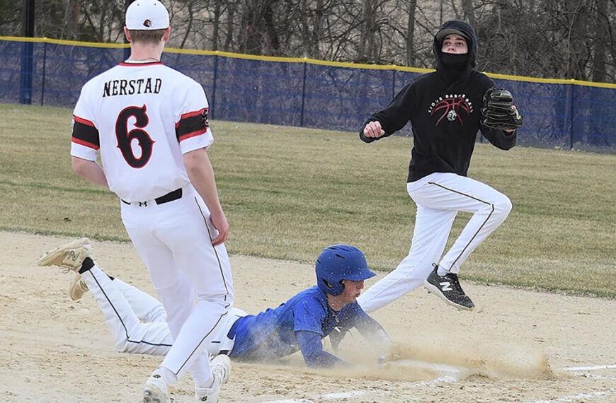Mabel-Canton’s Brevyn Tollefsrud slides into first safely as the ball comes toward Spring Grove’s Weston Ingvalson in the Cougars’ 6-2 SEC season-opening win. Photo by Lee Epps