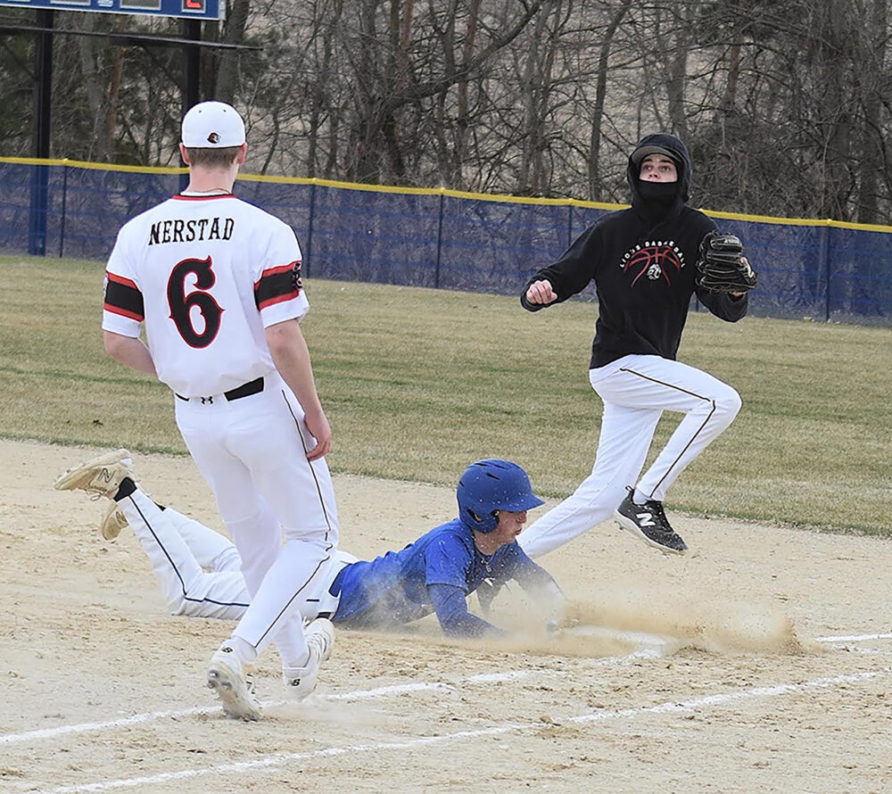 Mabel-Canton’s Brevyn Tollefsrud slides into first safely as the ball comes toward Spring Grove’s Weston Ingvalson in the Cougars’ 6-2 SEC season-opening win. Photo by Lee Epps