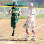 Rushford-Peterson Alannah Skalet scores an early run in the Trojans game with TRC-West leading St. Charles, but the Saints prevailed 11-4. Photo by Craig Johnson