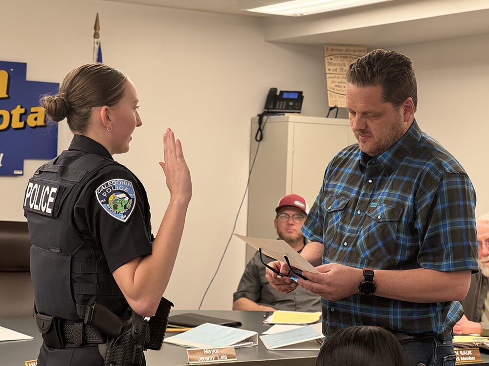 Mayor Jeremy Leis administered the oath of office to Caledonia’s new police officer, Gretchen Braun, at the April 13 council meeting. Photo by Charlene Corson Selbee