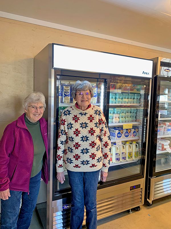 Volunteers Sharon Jahn and Rita Bezdicek show off some of the “cool new additions” at the Spring Valley Area Food Shelf. Photo submitted