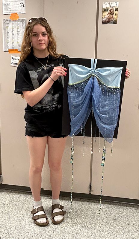 Gwen Lieb displays her top showing movement; the longer beads are attached bracelets which increase the movement in the piece.