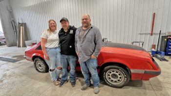 From left to right: Jasmine Schuler, Danny Marks and his dad Matt Helgeson pose with the Mustang. Photo by Wanda Hanson