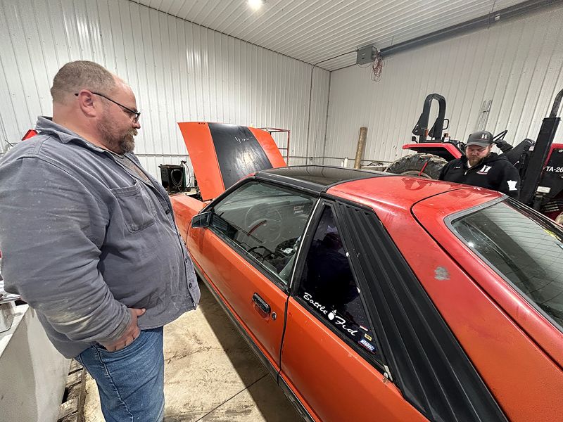 Matt shares some memories of the Mustang with Danny as they look it over. Photo by Wanda Hanson