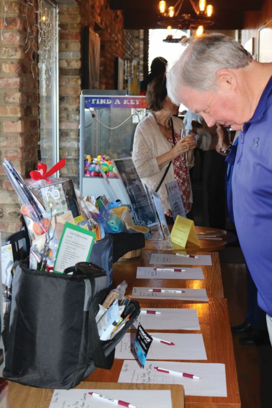 Preston Mayor Kurt Reicks takes a look at Silent Auction items during the PACF 2026 Annual Banquet held at the Branding Iron in Preston, Minn. Photo by Barb Jeffers