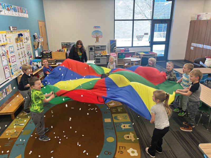 Preschoolers making it snow after reading “The Snowy Day” by Ezra Jack Keats. Photo submitted