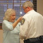 A proud moment as Police Chief Scott Keigley’s mother Virginia pins on his badge. Photo by Karen Reisner