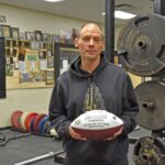 Coach Carl Fruechte emphasized that while the John Gagliardi Award ball bears his name, the honor reflects the efforts of the entire team. Photo by Charlene Corson Selbee