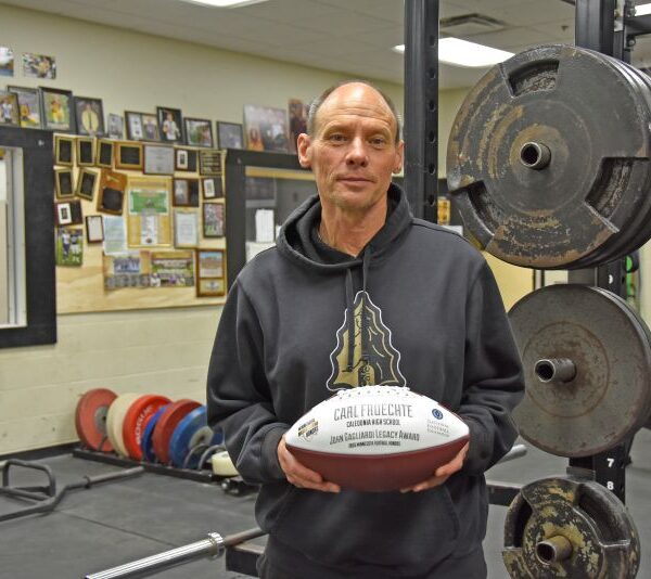 Coach Carl Fruechte emphasized that while the John Gagliardi Award ball bears his name, the honor reflects the efforts of the entire team. Photo by Charlene Corson Selbee