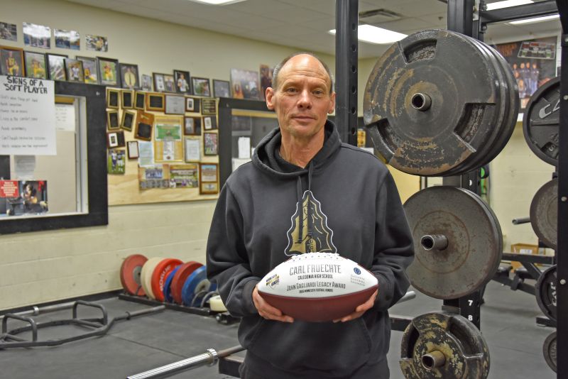 Coach Carl Fruechte emphasized that while the John Gagliardi Award ball bears his name, the honor reflects the efforts of the entire team. Photo by Charlene Corson Selbee